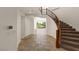Elegant foyer with a curved staircase, tile flooring, and an open view to the backyard at 2436 Grassy Spring Pl, Las Vegas, NV 89135