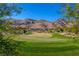 Scenic view of the golf course with well-manicured greens and mountain views in the background at 2436 Grassy Spring Pl, Las Vegas, NV 89135