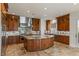 A kitchen featuring custom wood cabinetry, granite counters, and a stainless steel range hood at 2436 Grassy Spring Pl, Las Vegas, NV 89135