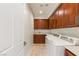 Functional laundry room with ample storage and modern washer and dryer units at 2436 Grassy Spring Pl, Las Vegas, NV 89135
