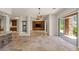 Large living area with tile floors, open concept, and custom built-in shelving with backyard access at 2436 Grassy Spring Pl, Las Vegas, NV 89135