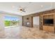 Living room featuring a stone accent wall with fireplace and balcony access at 2436 Grassy Spring Pl, Las Vegas, NV 89135
