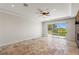 Living room featuring travertine floors and outdoor access to balcony at 2436 Grassy Spring Pl, Las Vegas, NV 89135