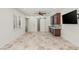 Spacious entertaining room with wine bar, mini fridge, and travertine tile floors at 2436 Grassy Spring Pl, Las Vegas, NV 89135