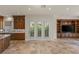 Open-concept living space with custom built-ins, stone floors, and access to outdoor space at 2436 Grassy Spring Pl, Las Vegas, NV 89135