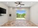 Sunlit bonus room with private balcony offering a stunning view, travertine floor and ceiling fan at 2436 Grassy Spring Pl, Las Vegas, NV 89135