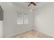 Inviting living room with stylish window shutters, travertine tile floors, and ceiling fan with light at 2436 Grassy Spring Pl, Las Vegas, NV 89135