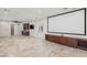 Large entertainment room featuring wet bar, projector screen, built-in cabinetry, travertine floor tiles at 2436 Grassy Spring Pl, Las Vegas, NV 89135