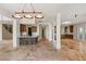 Spacious living room with stone floors, wet bar and access to multiple rooms in the home at 2436 Grassy Spring Pl, Las Vegas, NV 89135