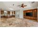 Open-concept living space with custom built-ins, stone floors, and access to outdoor space at 2436 Grassy Spring Pl, Las Vegas, NV 89135