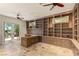 Home office featuring custom built-in bookshelves, desk, and an exterior door to a grilling area at 2436 Grassy Spring Pl, Las Vegas, NV 89135