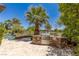 An outdoor kitchen features a stainless steel grill, stone accents, and ample counter space overlooking a sparkling pool at 2436 Grassy Spring Pl, Las Vegas, NV 89135