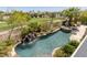 Aerial view of pool and hot tub featuring a waterfall and lush landscaping at 2436 Grassy Spring Pl, Las Vegas, NV 89135