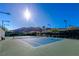 Outdoor tennis court featuring desert landscape with clear, sunny skies, perfect for enjoying an active lifestyle at 2436 Grassy Spring Pl, Las Vegas, NV 89135