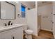Well-lit bathroom featuring neutral walls, white cabinets, marbled counters, and a shower behind a partition at 2448 Ram Crossing Way, Henderson, NV 89074