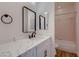 Bright bathroom with marble vanity, black hardware, updated fixtures, and pink tile in shower at 2448 Ram Crossing Way, Henderson, NV 89074