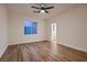 Bright bedroom with wood-look floors, a ceiling fan, and a window for plenty of natural light at 2448 Ram Crossing Way, Henderson, NV 89074