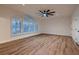Expansive bedroom with wood floors, ceiling fan, large windows, and white trim and baseboards at 2448 Ram Crossing Way, Henderson, NV 89074