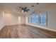 Spacious bedroom featuring wood floors, a ceiling fan, and large windows that allow natural light at 2448 Ram Crossing Way, Henderson, NV 89074