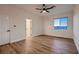Spacious bedroom with wood-look floors, ceiling fan and white trim throughout at 2448 Ram Crossing Way, Henderson, NV 89074