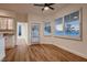 Cozy dining area with wood floors, modern lighting, and sliding glass door to backyard at 2448 Ram Crossing Way, Henderson, NV 89074