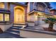 Charming home entrance with a large front door, well-lit, and manicured landscape at 2448 Ram Crossing Way, Henderson, NV 89074
