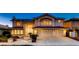 Charming two-story home featuring manicured landscaping, three car garage, and a red tiled roof at 2448 Ram Crossing Way, Henderson, NV 89074