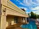 Back of home featuring a pool and a balcony with decorative railing and stucco exterior at 2448 Ram Crossing Way, Henderson, NV 89074