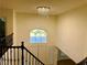 View from second story down into entry with front door, chandelier, and stairway with iron railing at 2448 Ram Crossing Way, Henderson, NV 89074
