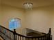View from second story down into entry featuring chandelier, stairway with iron railing, and entry at 2448 Ram Crossing Way, Henderson, NV 89074