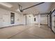Spacious three car garage featuring speckled flooring, ample lighting and storage at 2448 Ram Crossing Way, Henderson, NV 89074