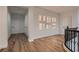 Bright second story hallway with wood floors, decorative nooks, and doors leading to bedrooms and other spaces at 2448 Ram Crossing Way, Henderson, NV 89074