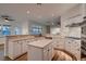 Spacious kitchen with white cabinets, island, stainless steel appliances, and tile backsplash at 2448 Ram Crossing Way, Henderson, NV 89074
