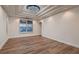 Bright living room with wood-look floors, recessed lighting, and window with shutters at 2448 Ram Crossing Way, Henderson, NV 89074