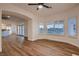 Bright living room with hardwood floors, white trim, large windows with shutters and views of the backyard at 2448 Ram Crossing Way, Henderson, NV 89074