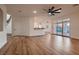 Spacious living room featuring wood floors, and access to staircase and pool area at 2448 Ram Crossing Way, Henderson, NV 89074