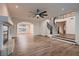 Open-concept living area featuring wood flooring, fireplace, staircase, and modern lighting at 2448 Ram Crossing Way, Henderson, NV 89074