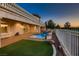 Backyard featuring an inground pool and spa, turf grass and partial fencing at 2448 Ram Crossing Way, Henderson, NV 89074