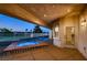 Covered patio with a tiled pool and spa overlooking a green landscape and neighborhood at 2448 Ram Crossing Way, Henderson, NV 89074