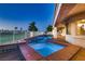 Inviting in-ground pool with spa, stone patio, wrought iron fence, and golf course views at 2448 Ram Crossing Way, Henderson, NV 89074