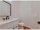 Modern half bathroom featuring a white vanity with marble countertop, black hardware, and modern sink at 2448 Ram Crossing Way, Henderson, NV 89074