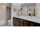 Bathroom featuring a double vanity, large mirror, and shower and tub combination at 2669 Via Monet, Henderson, NV 89044