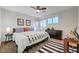 Bedroom featuring a large bed, ceiling fan, and nightstands at 2669 Via Monet, Henderson, NV 89044