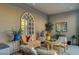 Relaxing sunroom boasts ample natural light, stylish seating, and decorative plants for serene living at 2669 Via Monet, Henderson, NV 89044