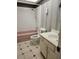 Bathroom featuring a pink bathtub, toilet, and white sink and cabinet at 2773 Heritage Ct, Las Vegas, NV 89121