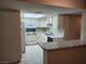 Charming kitchen with white appliances, countertops and a breakfast bar at 2773 Heritage Ct, Las Vegas, NV 89121