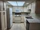 Charming kitchen with white appliances, and a sink with countertops at 2773 Heritage Ct, Las Vegas, NV 89121