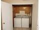 Convenient laundry room features a washer, dryer, and wooden cabinets for easy storage and organization at 2773 Heritage Ct, Las Vegas, NV 89121