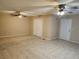 Spacious living room features tile flooring, two ceiling fans, and neutral paint, providing a comfortable, move-in-ready space at 2773 Heritage Ct, Las Vegas, NV 89121