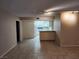 Open living space with tile flooring, connecting to the kitchen with a breakfast bar at 2773 Heritage Ct, Las Vegas, NV 89121